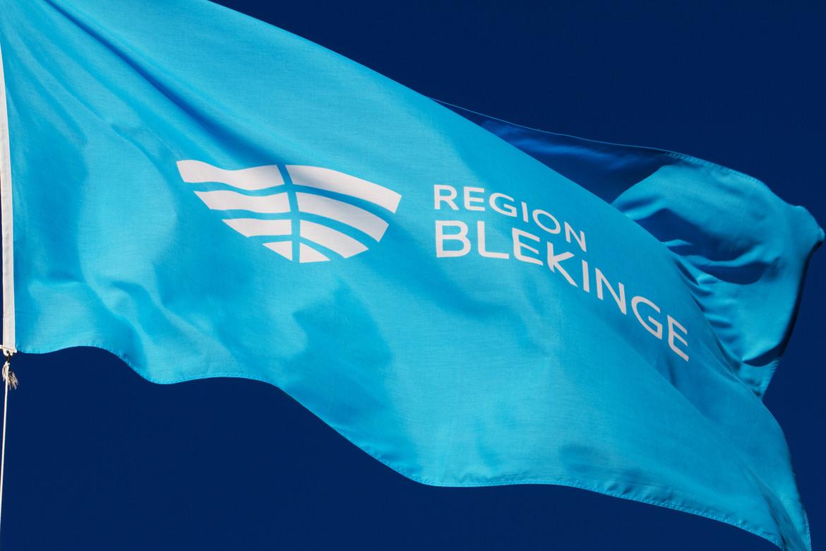 Blå flagga med Region Blekinges vita logotyp