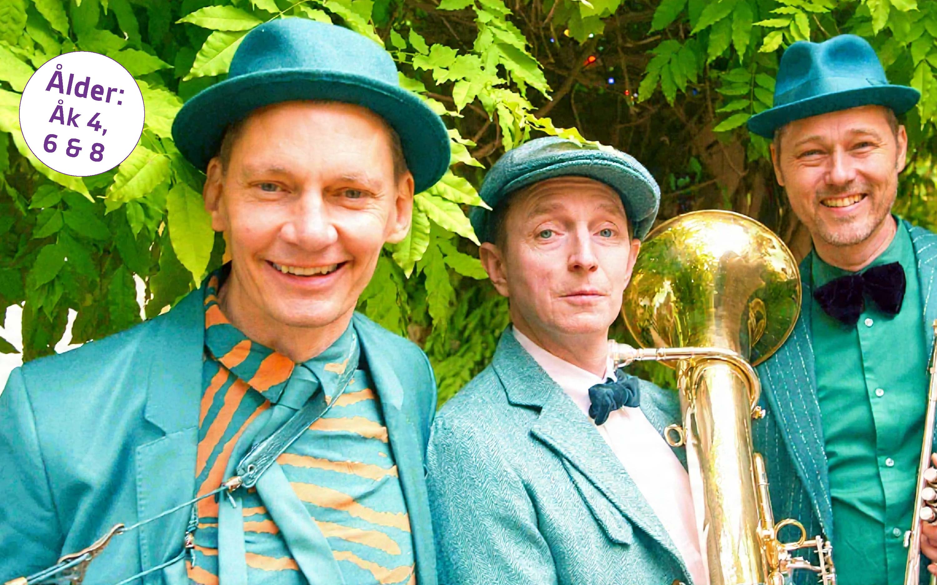 tre glada män med instrument iklädda tukosa kostymer och hatt