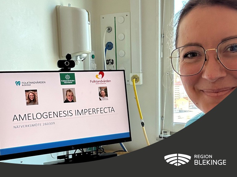 En kvinna ler och tittar mot kameran. Bakom henne ser man en datorskärm där det står Amelogenesis imperfecta
